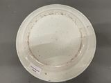 a white bowl that has some dirt on it