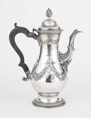 an antique silver coffee pot with a black handle on a white background