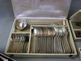 a wooden box with silverware in it on a table