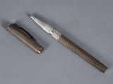a pen and a ballpoint pen sitting on a table
