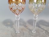 three wine glasses sitting next to each other on a table