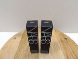 two black boxes of nars cosmetics on a wooden table