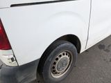 a white truck with a flat tire parked in a parking lot
