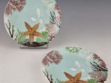two plates with starfishs on them sitting on a table