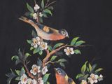 two birds sitting on a branch of a tree with flowers