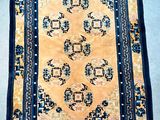 an oriental rug on the ground with a blue border and a yellow background
