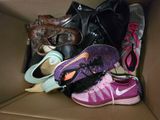 many pairs of shoes in a box on the floor