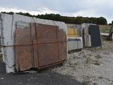 a pile of granite blocks sitting on the side of the road