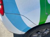 a white car with a green and blue stripe on it