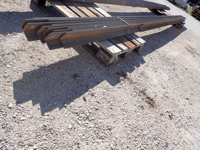 several pieces of steel sit on top of a pile of wood