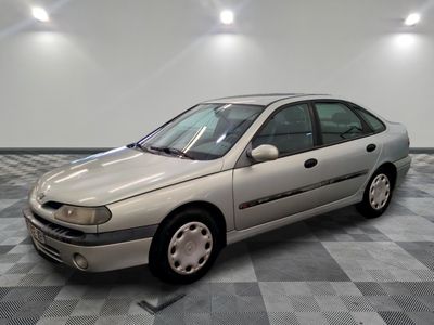 a silver car that is sitting on a checkered floor