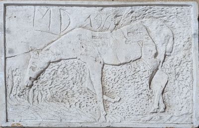a relief of a horse on the wall of a building