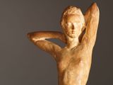 statue of a woman holding her hands behind her head with her hands behind her head
