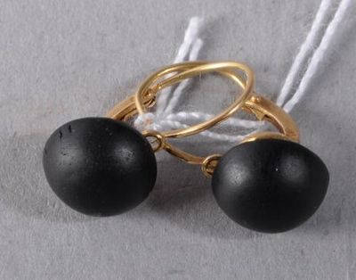 pair of black bead earrings with gold plated hoops on a white string