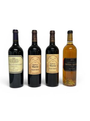 three bottles of wine are lined up on a white surface