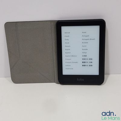 a kindle that is sitting on a table next to a book