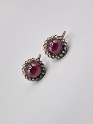 a pair of ruby and diamond earrings