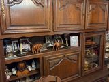 a large wooden china cabinet in the corner of the room