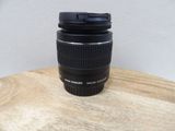 a camera lens sitting on top of a wooden table