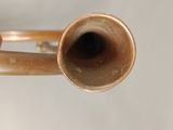 a close up of a trumpet with a hand holding it