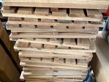 a large stack of wooden planks stacked on top of each other