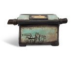 a small box with a picture of a tree on it