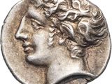 a silver coin with an image of a man ' s head on it