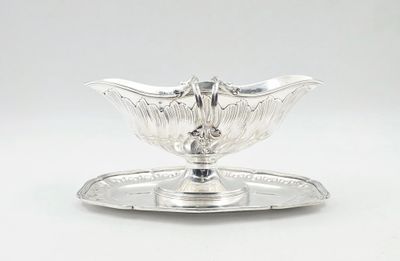 a silver plate with a bird on it and a tray underneath it