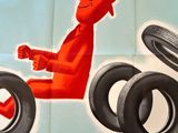 a poster of a man riding a motorcycle with tires