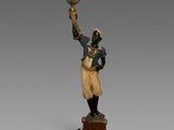une image représentant une statue d'un homme tenant un oiseau dans la main
