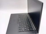 a laptop computer sitting on a table with a keyboard