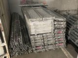 many piles of steel bars stacked on top of each other
