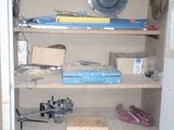 an open cabinet with a lot of items on it
