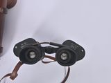 a pair of binoculars sitting on a table next to a pair of glasses
