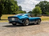 an image of a blue sports car parked on the side of the road