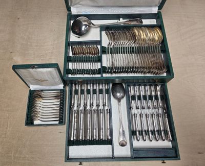 a green case with silverware in it on a table
