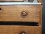 a wooden dresser with a mirror on top of it