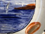a plate with a picture of a sailboat on it