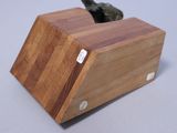 a wooden block with a knife in it on a table