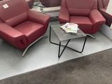 two red chairs and a table in a room