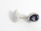 a close up of a pair of cufflinks with a world map on it
