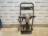 a close up of a machine on a stand in front of a wall