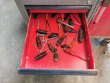 many tools in the drawer of a red toolbox