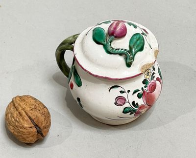 a nut and a teapot sitting on a table