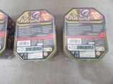 two boxes of pokemon cards sitting on top of a table