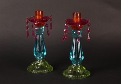 pair of colorful glass candlesticks on a black background