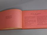 an open book on a table with a pink cover and yellow pages