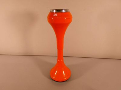an orange vase with a silver top on a table