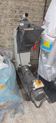 a pile of garbage sitting on the ground next to a trash can
