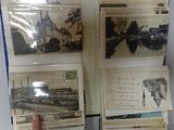 several old postcards are stacked on top of each other on a table